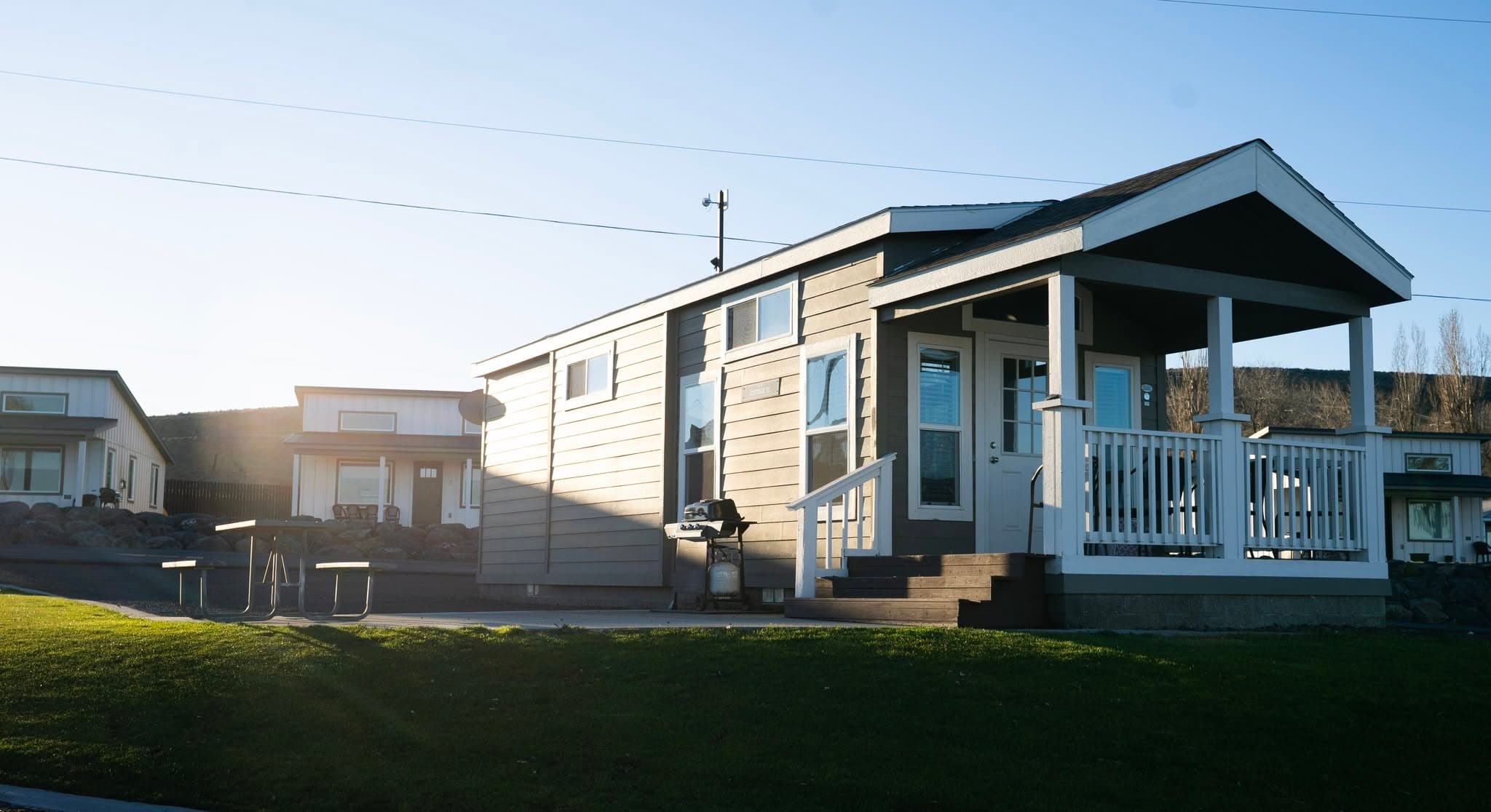 A MarDon lake house with a covered porch at golden hour
